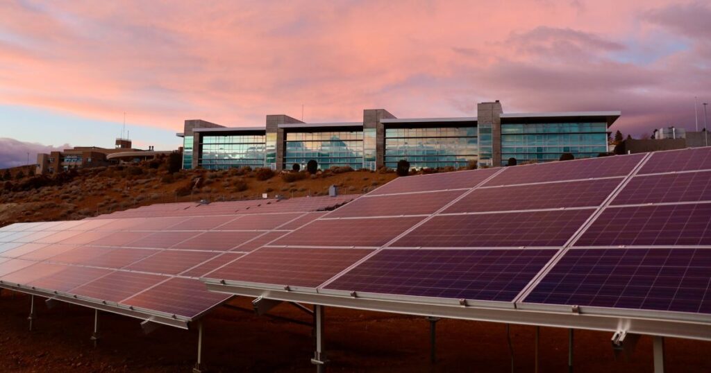 Solar panels with sunset in the background.