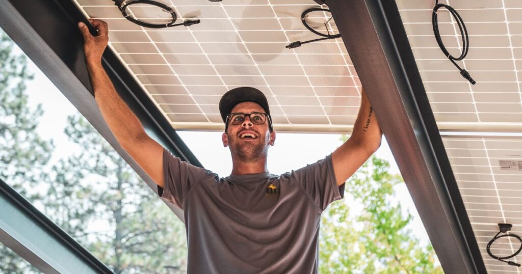 A DC Solar Electric employee installing solar panels