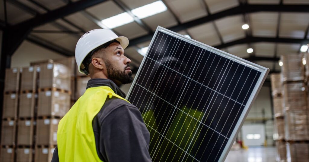 Employee installing solar into their company’s small business.
