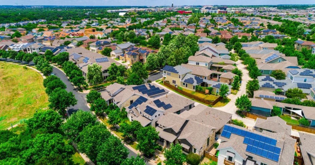 A neighborhood using solar energy with lots of homes with solar panels.